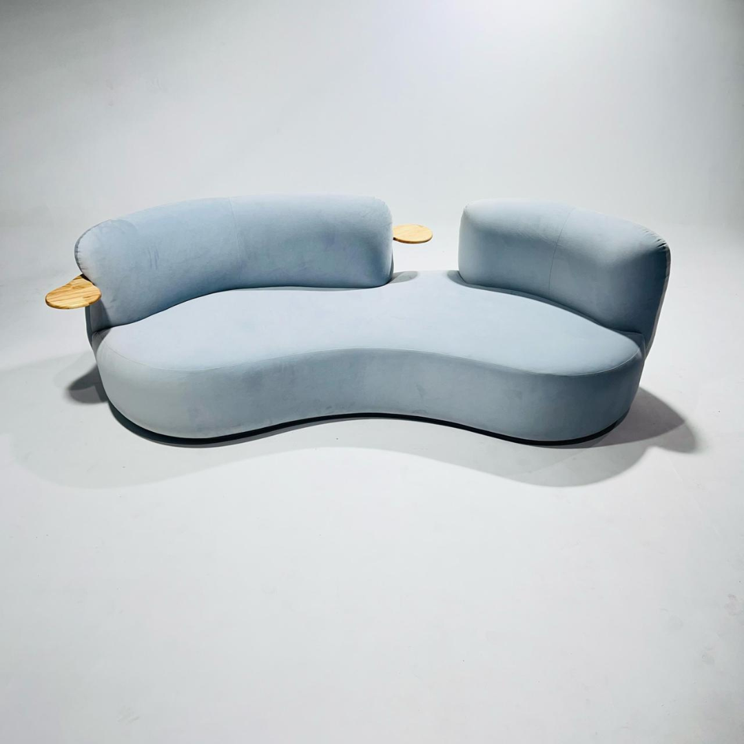 Modern light blue sofa with wooden accents on a white background